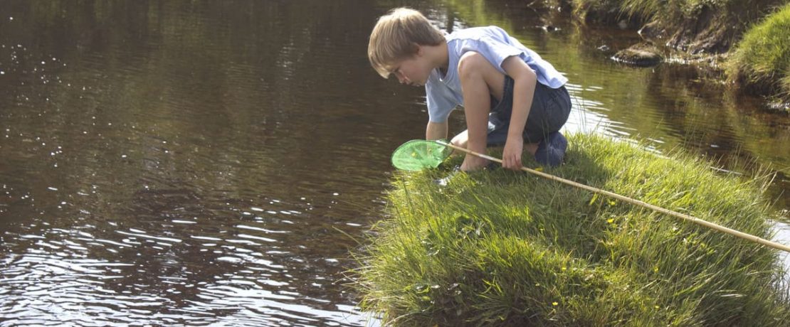 Boy fishing river