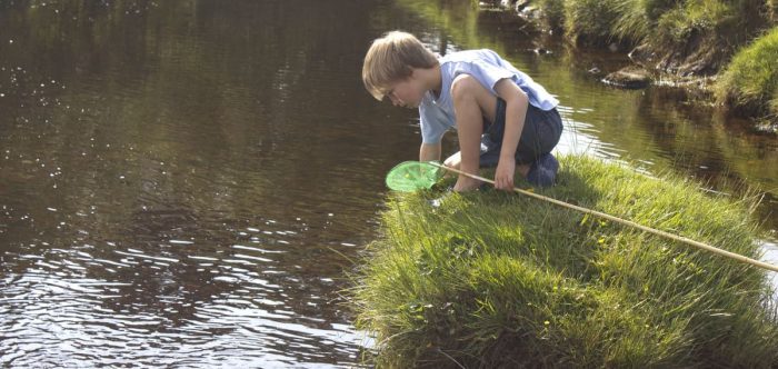 Boy fishing river