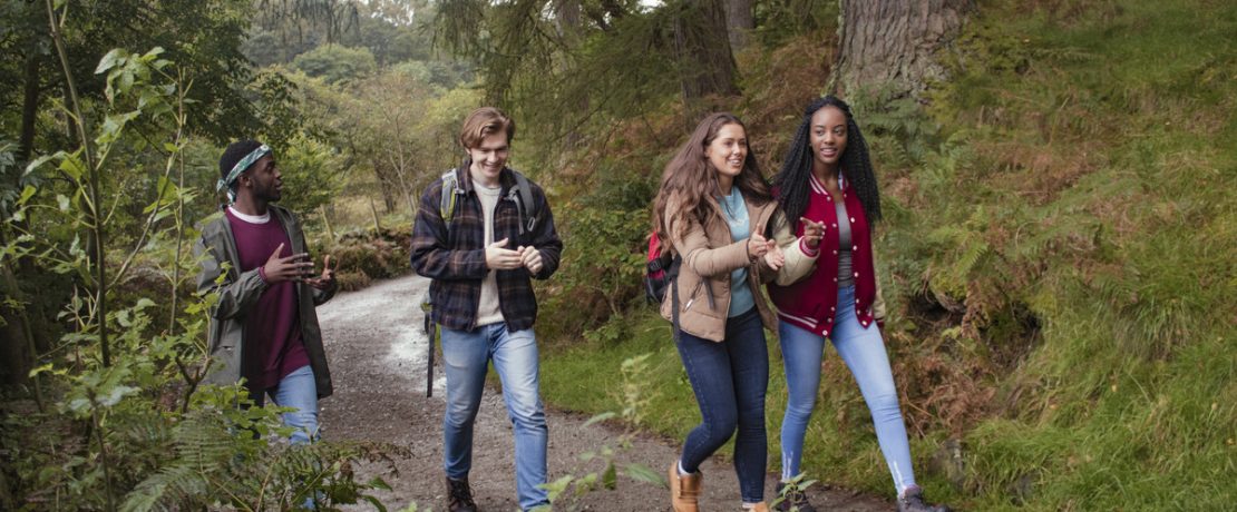 Young people walking in woodland